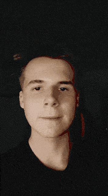 a close up of a man 's face in the dark