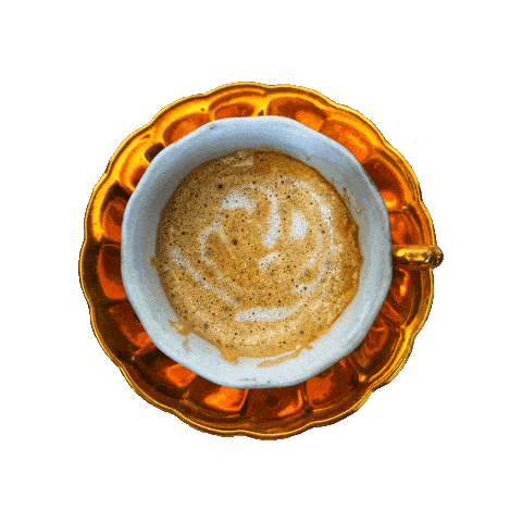 a cup of coffee on a saucer with a smiley face on the foam