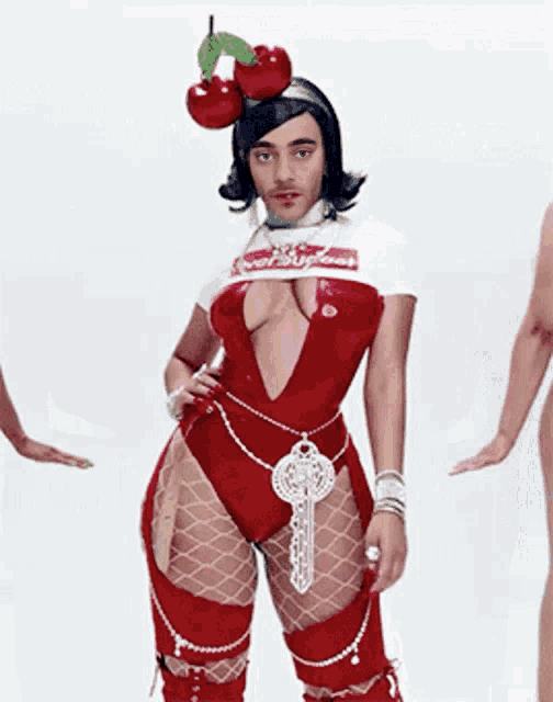 a woman in a very revealing outfit has cherries on her head