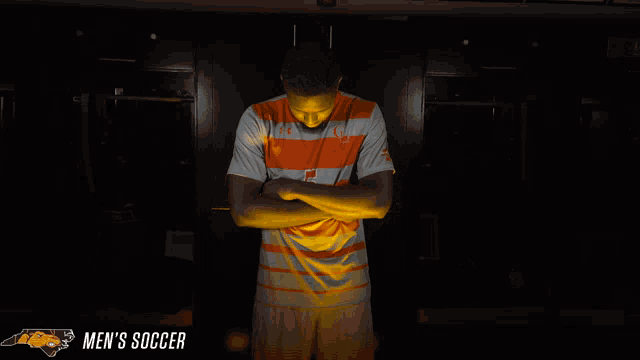 a man in an orange and white striped shirt with the number 5 on the front