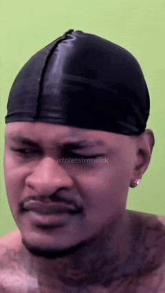 a man wearing a black beanie has a tattoo on his chest