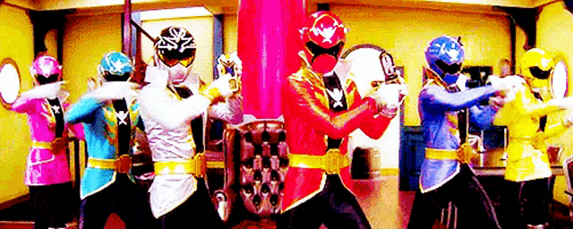 a group of power rangers are standing next to each other in a room