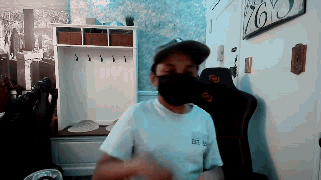 a man wearing a mask and a white shirt that says est. 35