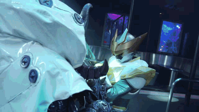 a man in a white costume is sitting in front of a screen