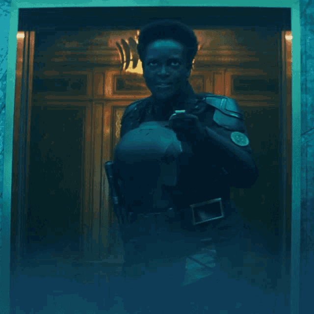 a man is holding a knife in front of a door