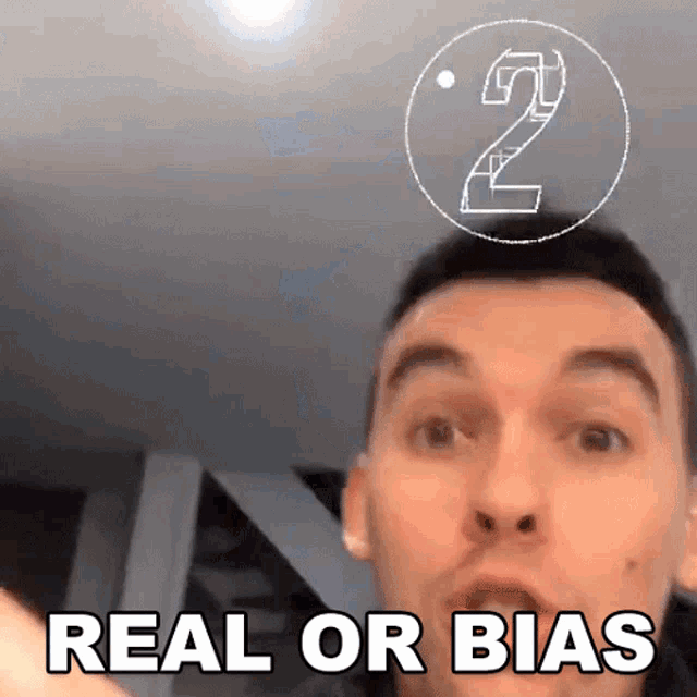 a man says " real or bias " in front of a drawing of a number 2