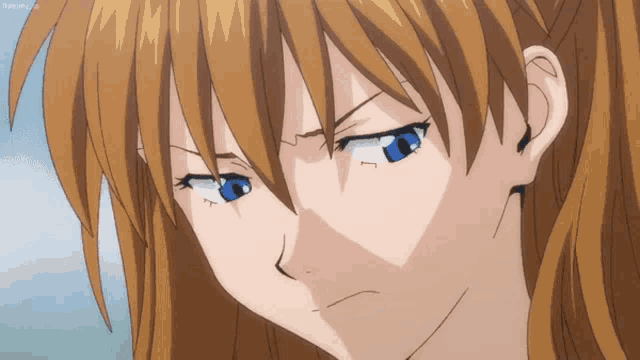 a close up of a girl 's face with a serious expression