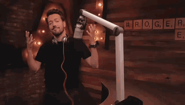 a man wearing headphones is dancing in front of a microphone