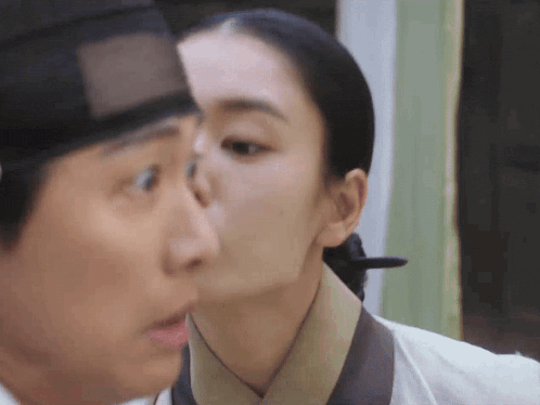 a man and a woman are kissing each other .