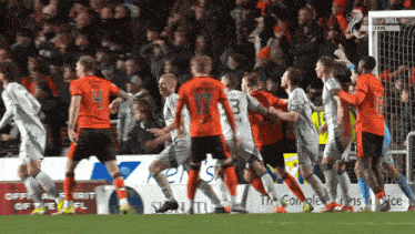 a group of soccer players on a field with one wearing number 3