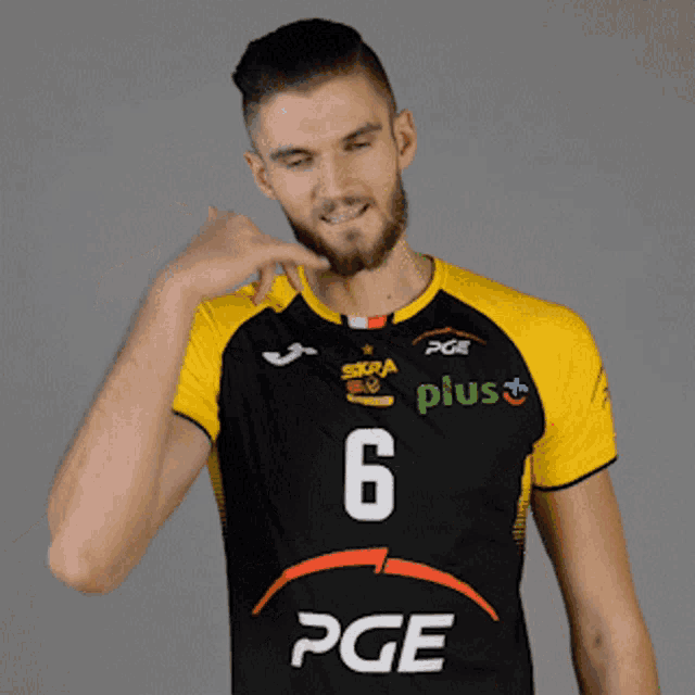 a man in a black and yellow pge jersey