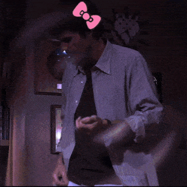 a man in a suit and tie with a hello kitty bow on his forehead