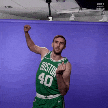 a man in a green boston 40 jersey is dancing