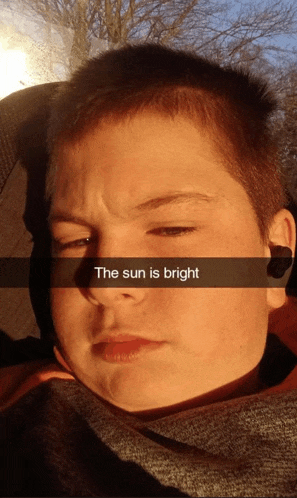 a young boy taking a selfie with the caption the sun is bright