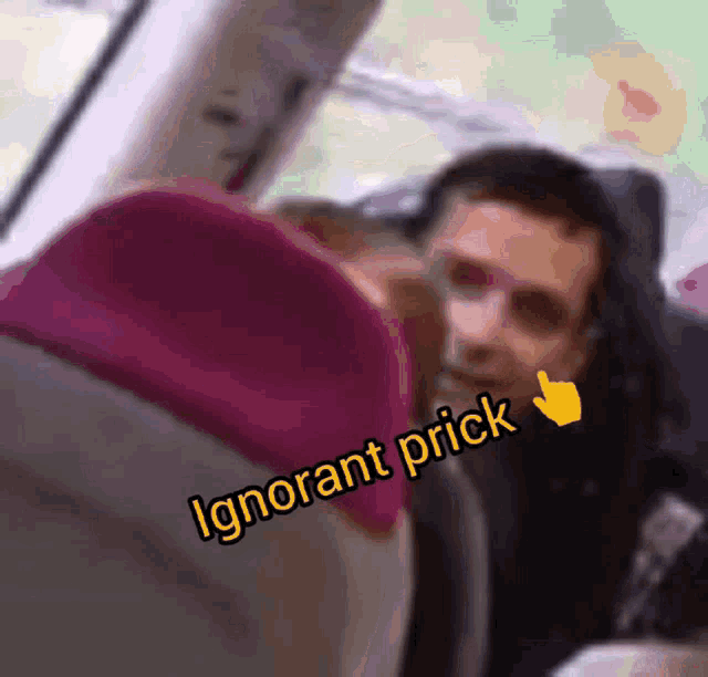 a blurry picture of a man with the words " ignorant prick " written below him