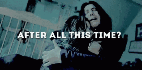 a man is hugging a woman in a dark room with the words `` after all this time ? '' written above them .