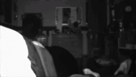 a person is sitting in a chair in a dark room .