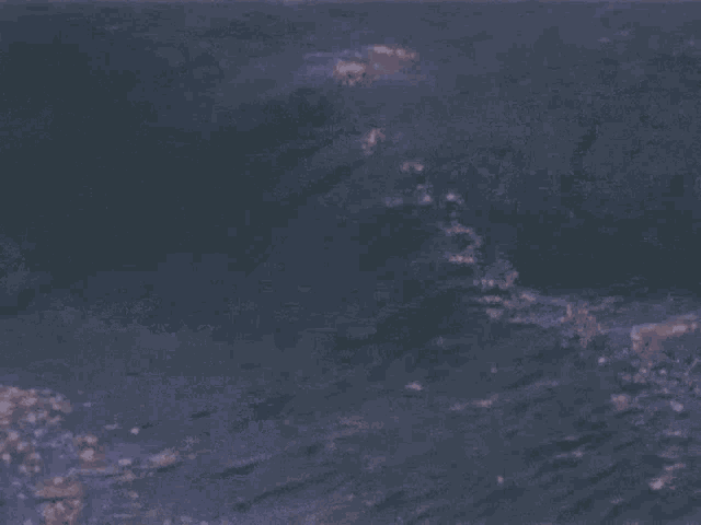 a dark blue background with a few white spots