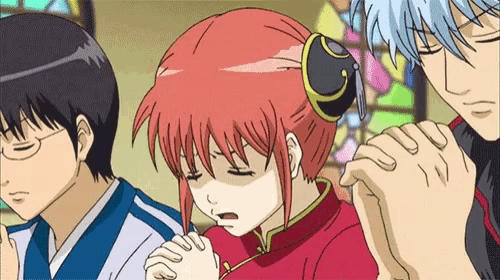 a group of anime characters are praying with their hands folded .