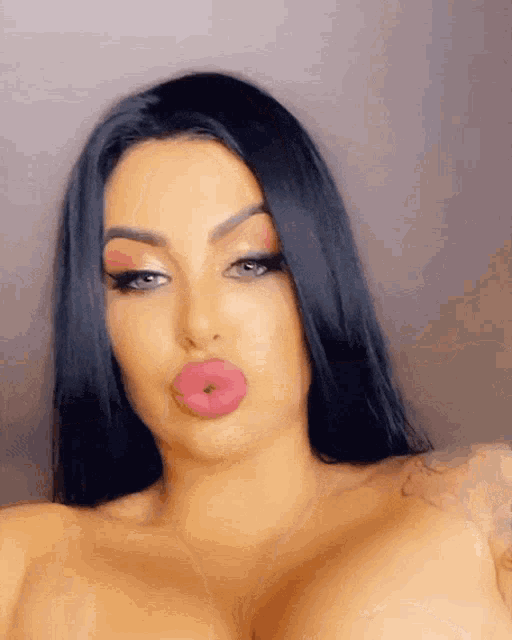 a close up of a woman 's face with big lips