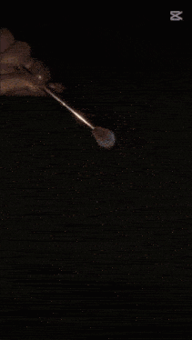a person is holding a brush in front of a pile of glitter with the number 00 on the bottom