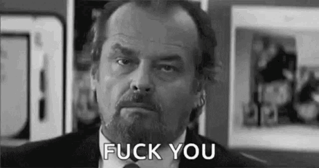 a black and white photo of a man with a beard and tie saying `` fuck you '' .