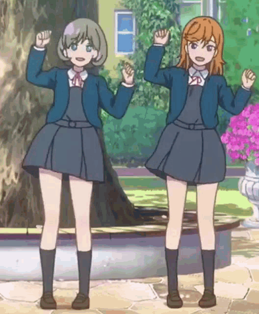 two anime girls are standing next to each other in front of a tree .