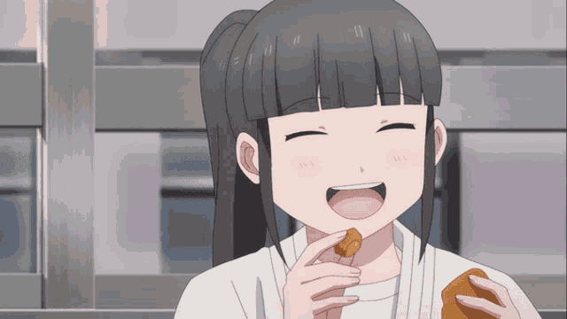 a girl with a ponytail is smiling and eating a piece of food