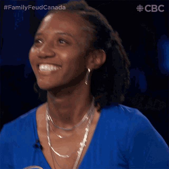 a woman wearing a blue shirt that says " arienne " on it