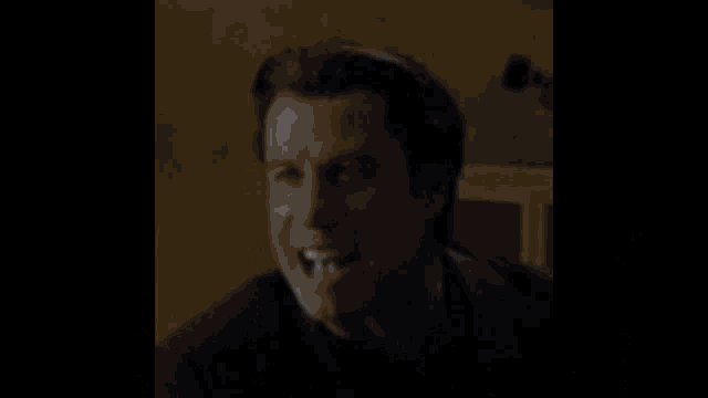 a man in a black shirt is surrounded by water drops
