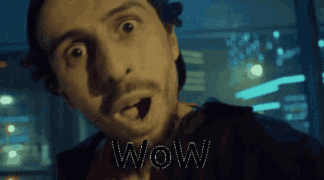 a man with a surprised look on his face and the word wow written on his face