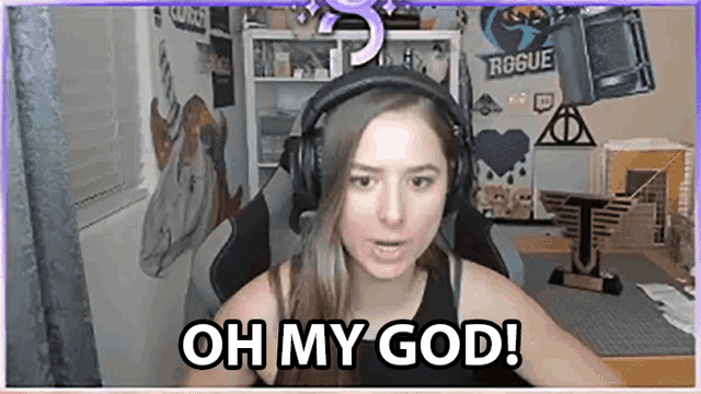 a woman wearing headphones says oh my god while sitting in a chair .