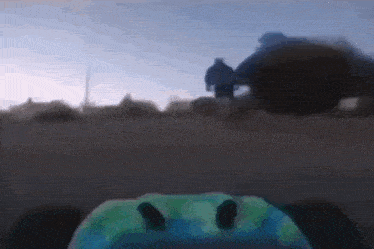 a blurry picture of a person wearing a helmet with a smiley face on it