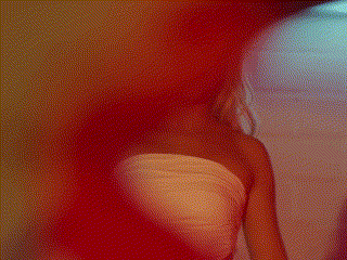 a blurry picture of a woman 's back with a red and yellow background