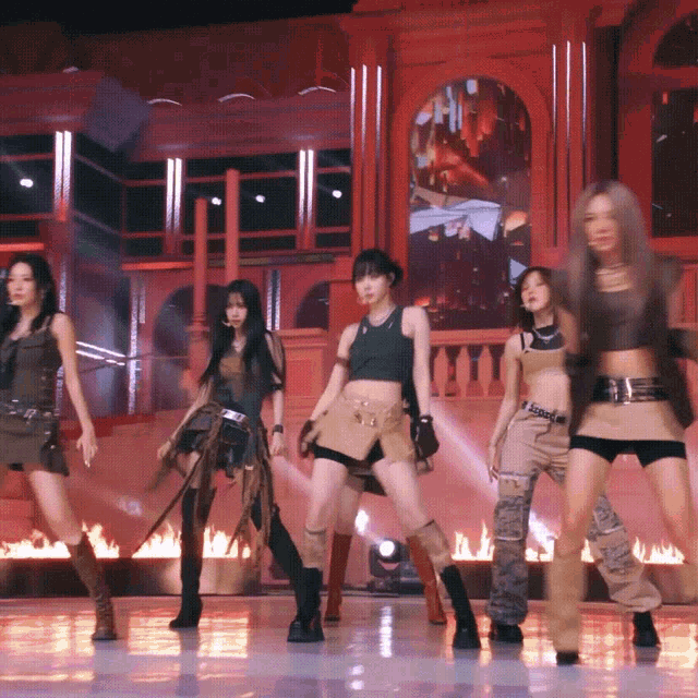 a group of women are dancing in front of a building