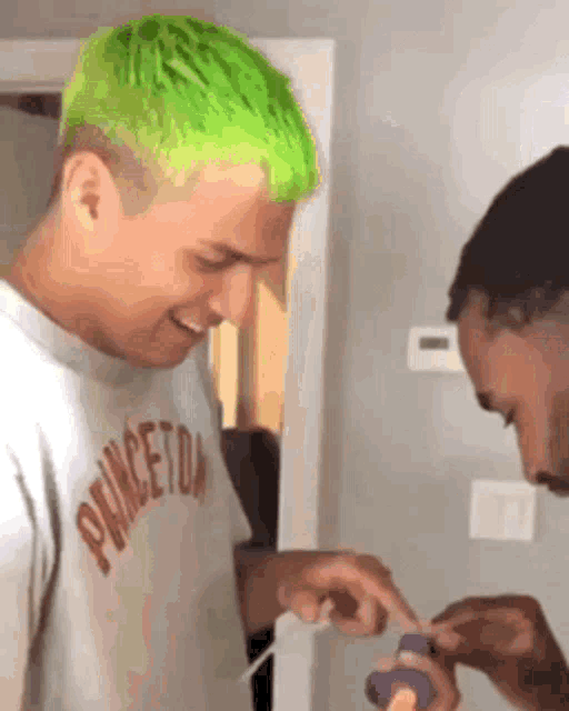 a man with green hair is wearing a shirt that says princeton .