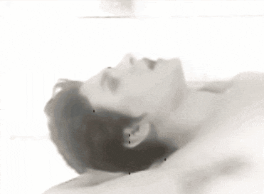 a black and white photo of a naked woman laying on her back