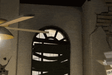 a room with a ceiling fan and a sign that says 03c