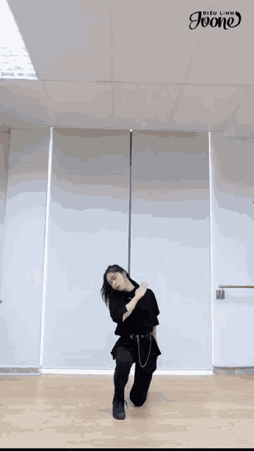 a woman is dancing in a room with a sign that says ' joon ' on it