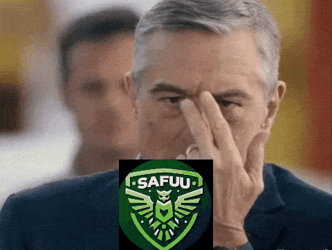 a man covering his face in front of a safuu emblem