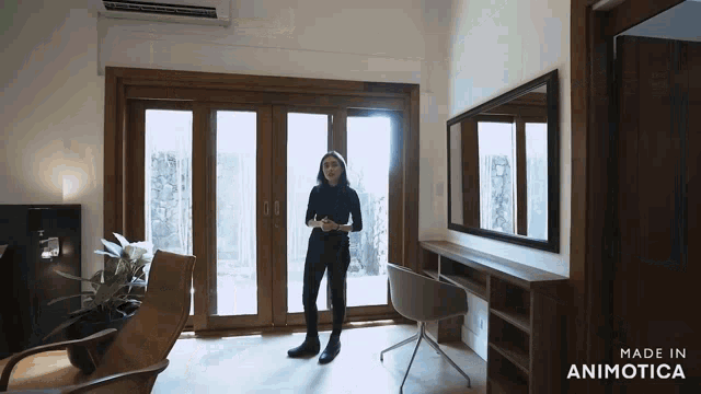a woman is standing in a room with the words made in animotica on the bottom right