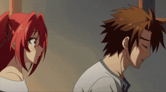 a man and a woman are standing next to each other and the woman has red hair