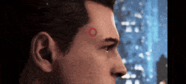 a close up of a man with a red circle on his forehead .