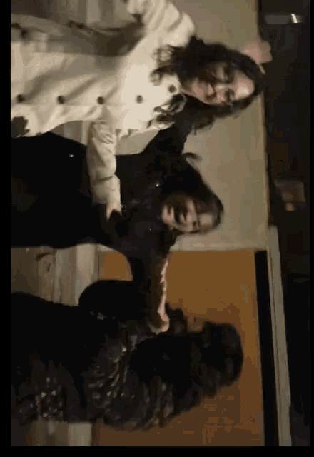 a woman in a trench coat stands next to another woman