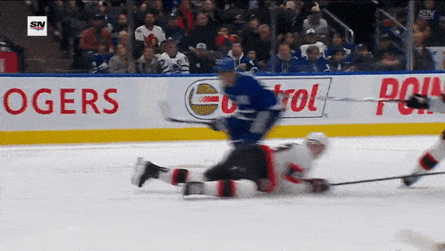 a hockey game is being played in front of an advertisement for castrol