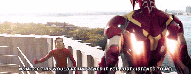a man in a spiderman suit stands next to a man in a iron man suit
