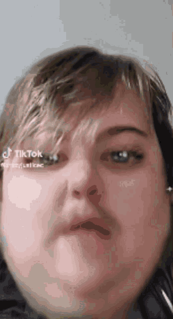 a close up of a person 's face with their mouth open and their eyes closed .