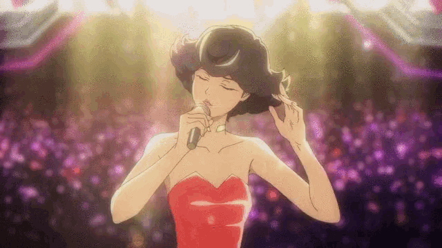 a woman singing into a microphone with her eyes closed