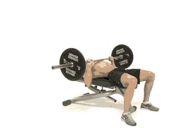 a man is lifting a barbell with hammer strength plates on it