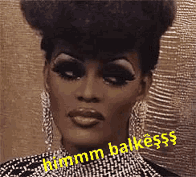 a close up of a drag queen 's face with a caption that says hmm balkesss